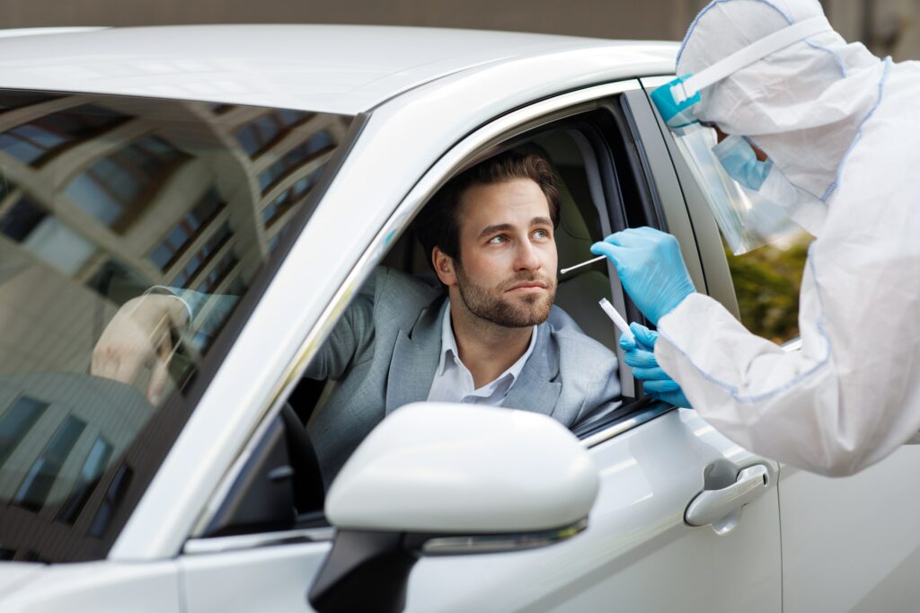 Doctor taking nasal swab from person to test for possible covid-19 infection