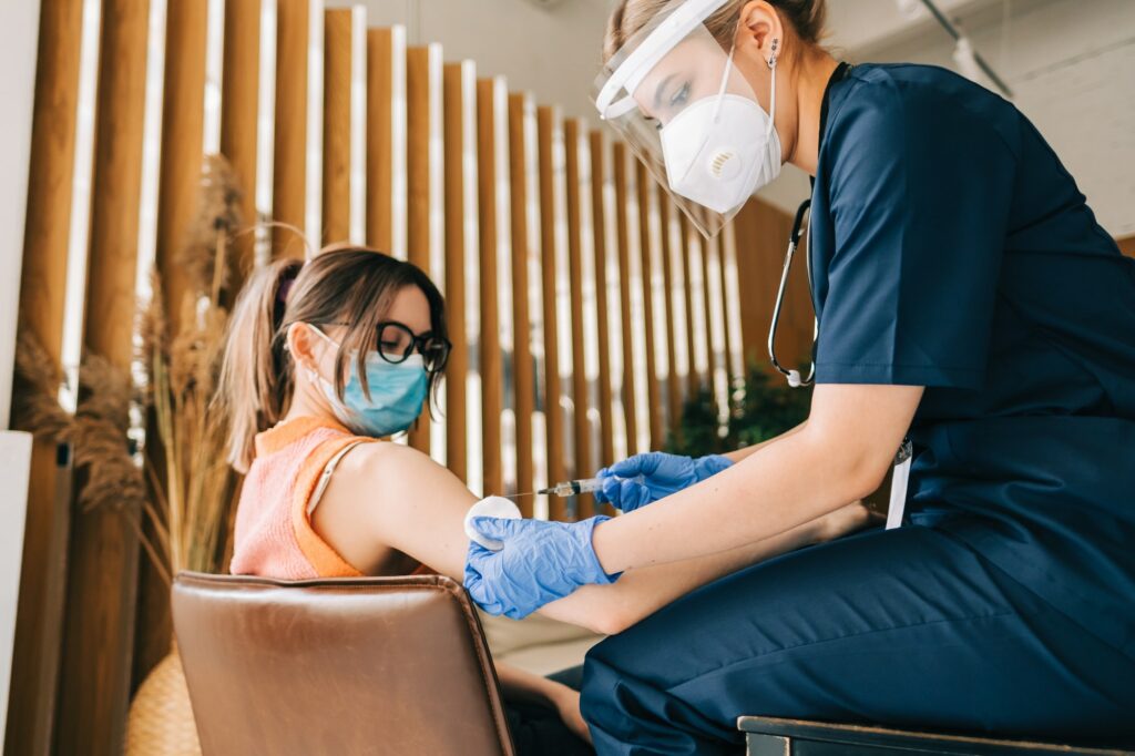 Caucasian woman patient getting vaccinated against coronavirus receiving covid vaccine