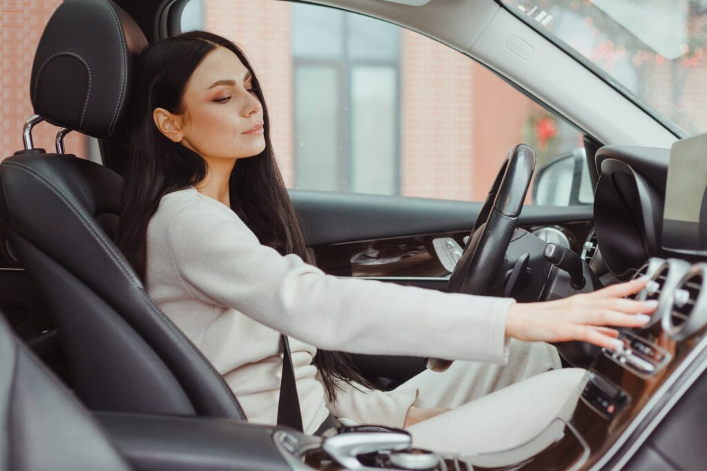 Woman turning on car air condition system on dashboard in car panel, Auto car air condition Woman turning on car air condition system on dashboard in car panel, Auto car air condition
