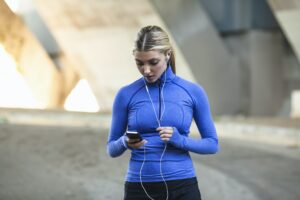 Jogger selecting music on smartphone