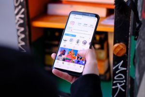 Woman scrolling Instragram on her phone
