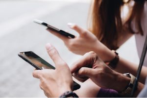 Close up of two people on their smart phones